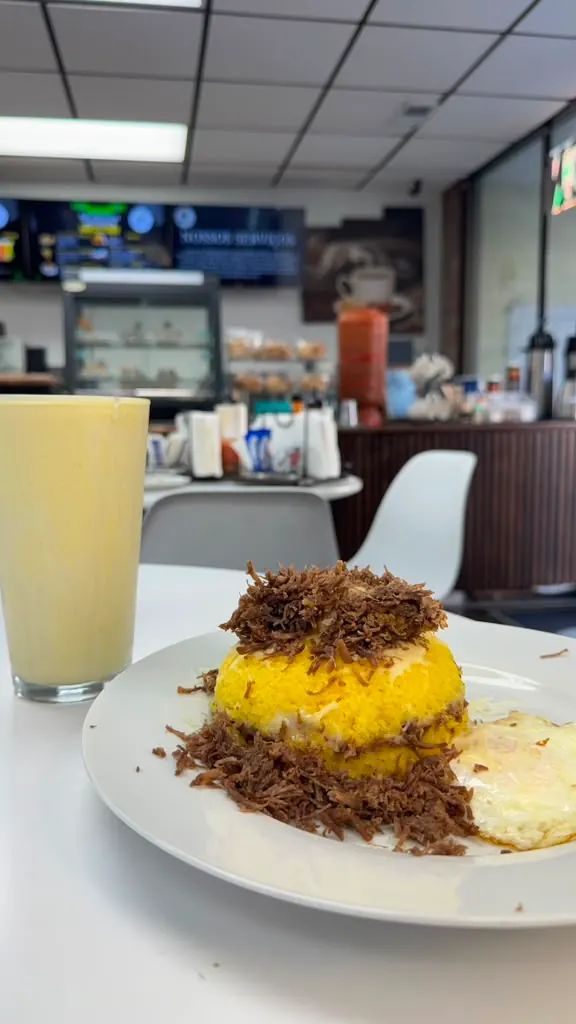 Brazilian cuscuz with carne seca, egg and fresh juice served at Paradise